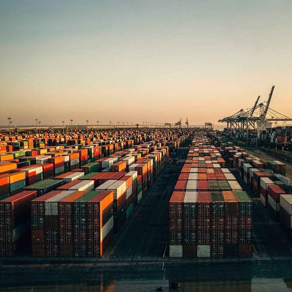 Container terminal at a Chinese port, with stacked shipping containers and gantry cranes
